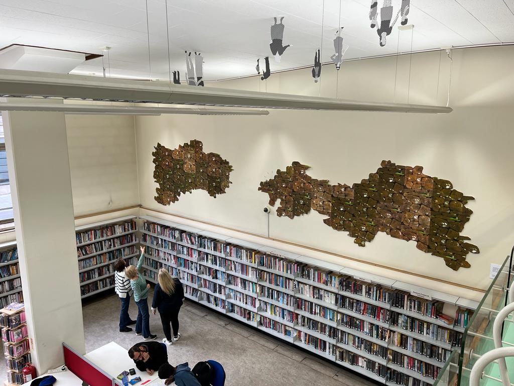 Image of an installation view of Carolyn Murphy's work, called A World We Share?, on the wall at Holborn Library